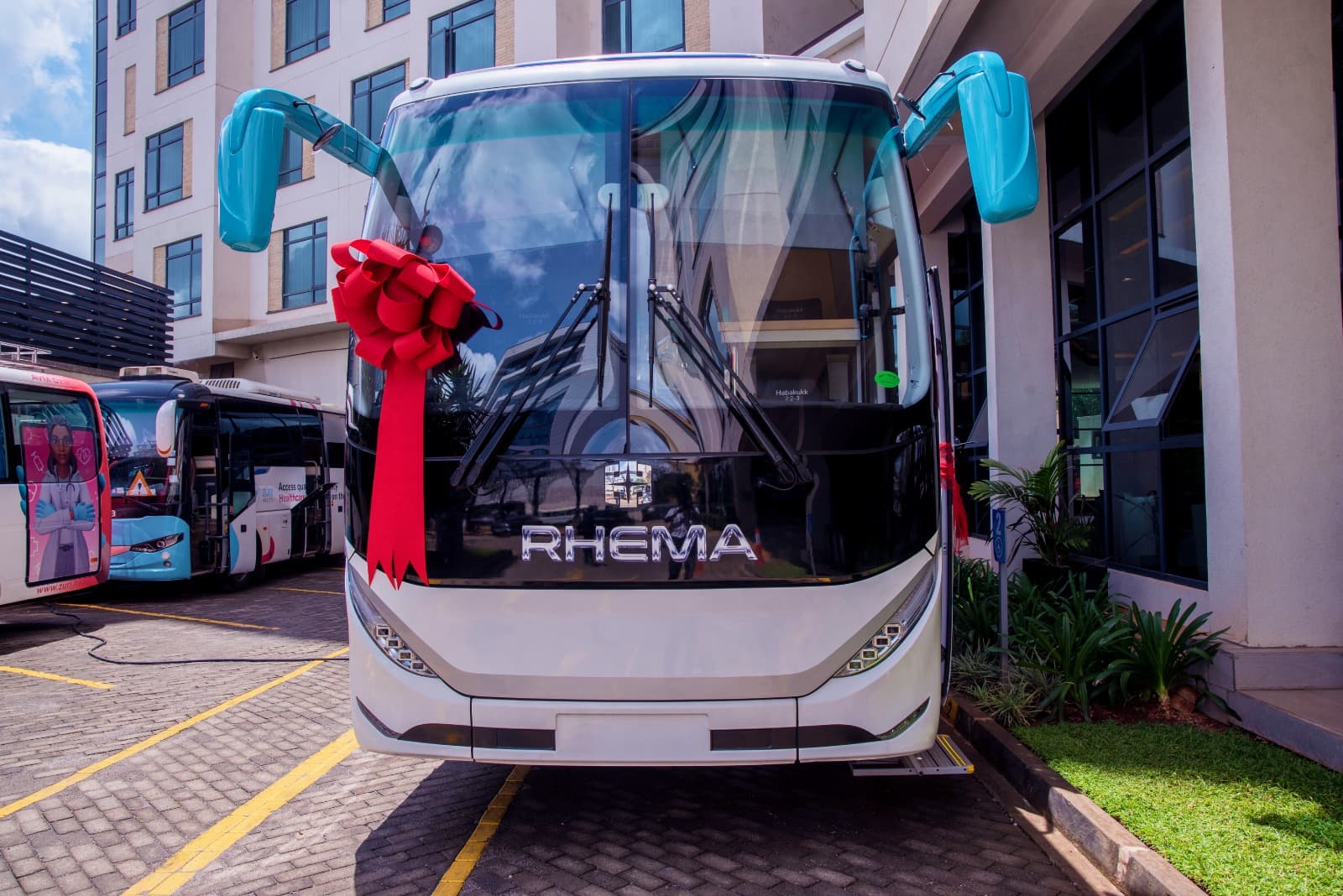 Front view of the Zuri Express mobile hospital bus with a red ribbon